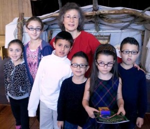 Pastor Mary Bacheller with children at Sunday Christmas service