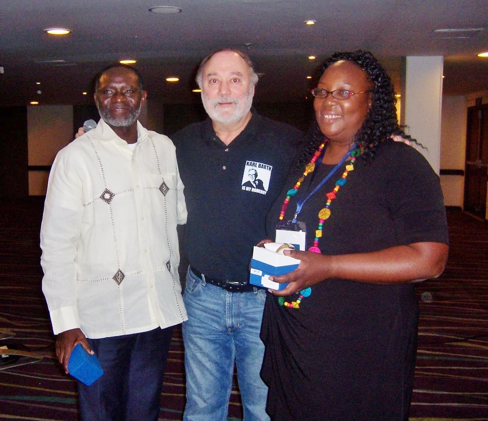 Kalengule Kaoma (MD from Africa) and his wife Nasama receive watches in recognition of 25 years of ministry within GCI.