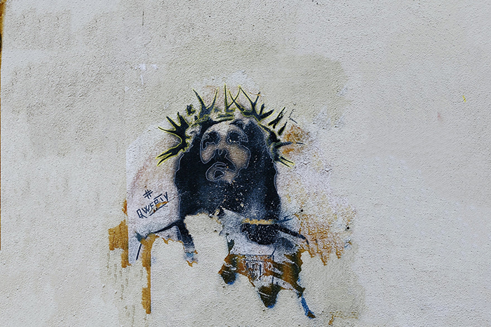 a street art image of jesus looking to the sky