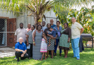 Mike Rasmussen, Greg Williams, and GCI members who survived Hurricane Dorian pose outside for a photo in Nassau, Bahamas.