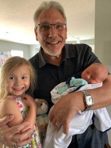 GCI President Greg Williams holds his newborn grandson Everett, as his granddaughter and new big sister Emory looks on excitedly