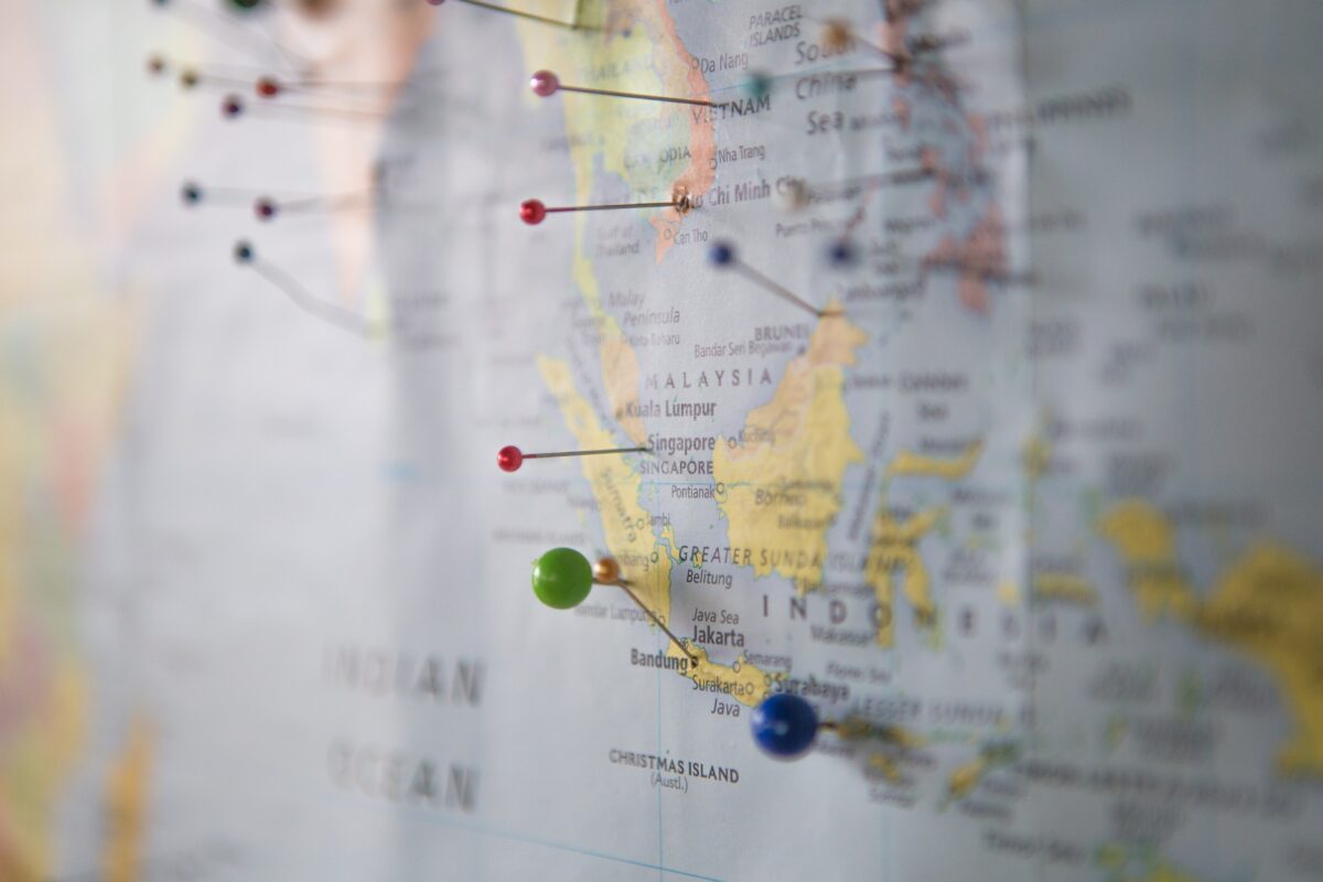 Photo of a paper map of Indonesia with pins