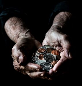 Aged hands holding coins